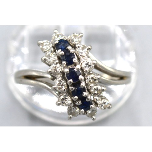 133 - A Platinum Diamond And Sapphire Ring set with five sapphires surrounded by diamonds within a pierced... 