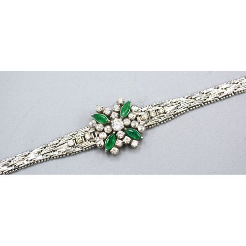 142 - An 18ct White Gold Diamond And Emerald Set Bracelet with a central diamond surrounded by four marqui... 