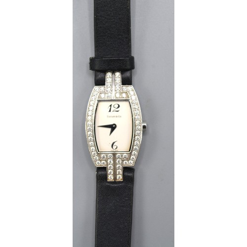 149 - Tiffany & Co. 18ct. White Gold Tonneau Diamond Set Ladies Wrist Watch, a black leather strap set wit... 