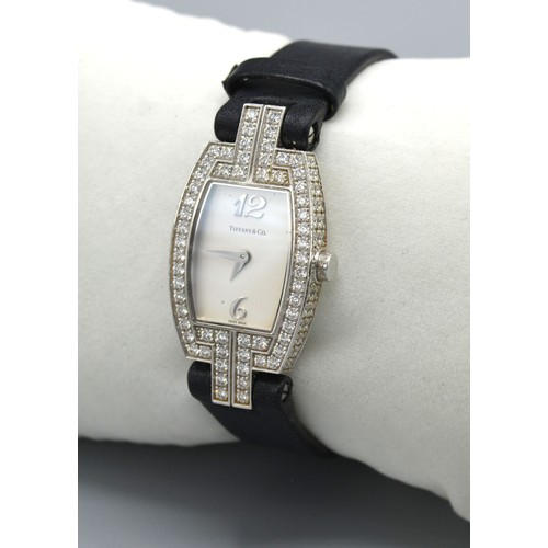 149 - Tiffany & Co. 18ct. White Gold Tonneau Diamond Set Ladies Wrist Watch, a black leather strap set wit... 