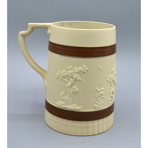 23 - A Staffordshire Brown Glazed Stoneware Tankard by John Turner decorated in relief with classical fig... 