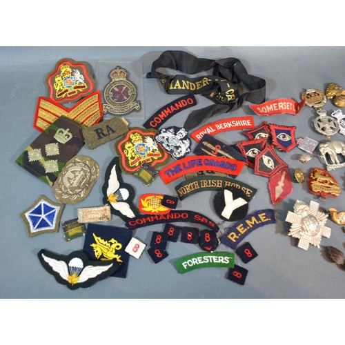 381 - A Collection Of Military Cap Badges together with a collection of military cloth badges and buttons