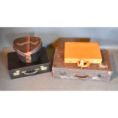 409 - A Leather Dressing Case together with a similar suitcase, a leather hat box and a briefcase