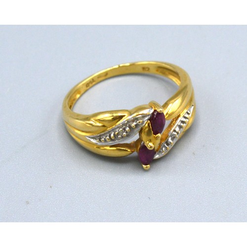 273 - An 18ct Yellow Gold Diamond And Ruby Ring set with two rubies flanked by diamonds within a crossover... 