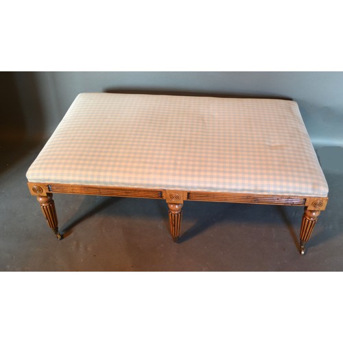 553 - A 19th Century Mahogany Rectangular Large Stool, the padded seat above a reeded frieze and raised up... 