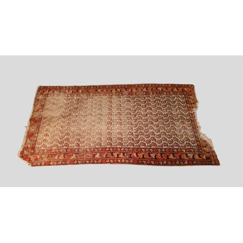 472 - A North West Persian Woollen Rug with an all over design upon a blue red and cream ground within mul... 