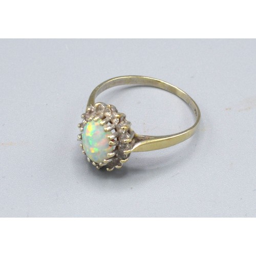 332 - A 9ct. Gold Dress Ring set oval opal type stone surrounded by cubic zirconia claw set