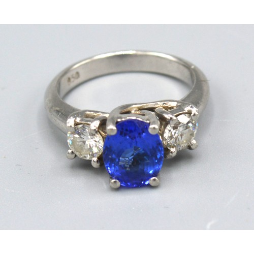 101 - A Platinum Tanzanite And Diamond Ring with an oval cut tanzanite approximately 2.0 ct flanked by two... 