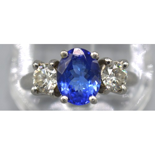 101 - A Platinum Tanzanite And Diamond Ring with an oval cut tanzanite approximately 2.0 ct flanked by two... 