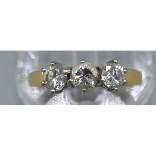 111 - An 18ct. Yellow Gold Three Stone Diamond Ring set  within a pierced setting, approximately 0.90 ct. ... 