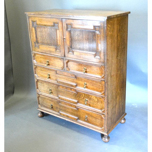 380 - An Oak Triple Wardrobe In 18th Century Style with three moulded doors raised upon low bun feet 152 c... 