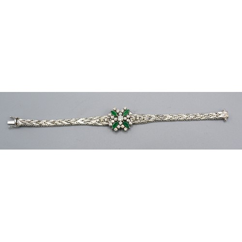 184 - An 18ct White Gold Diamond And Emerald Set Bracelet with a central diamond surrounded by four marqui... 