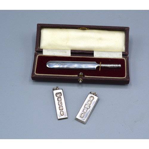 364 - A London Silver Model Of A Cricket Bat Within Fitted Case together with two silver ingot pendants