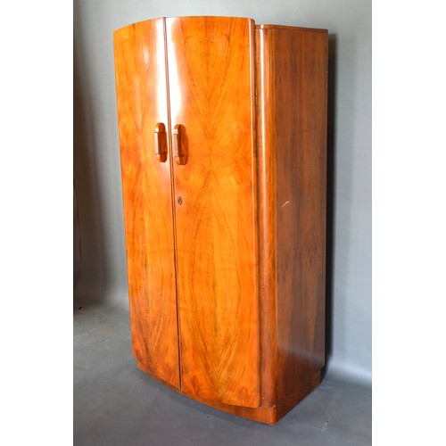 599 - An Art Deco Walnut Bedroom Suite comprising dressing table, two wardrobes and a bedstead