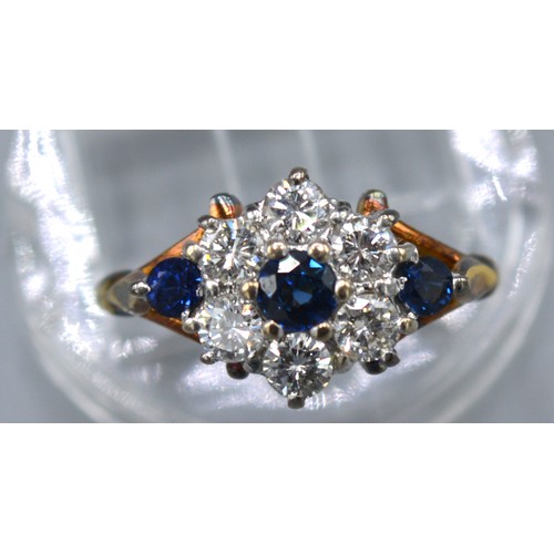 421 - A 9ct. Yellow Gold Diamond And Sapphire Cluster Ring set with six central sapphires surrounded by di... 