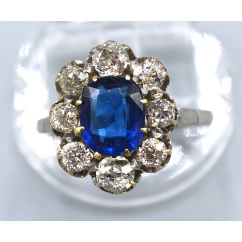 429 - An 18ct. White Gold Diamond and Blue Stone Cluster Ring with a central blue stone surrounded by eigh... 