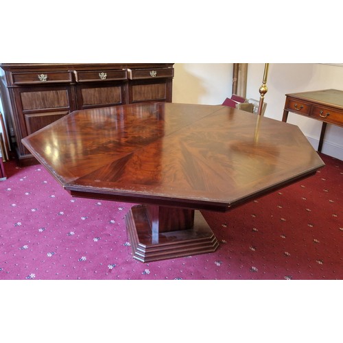 662 - A 20th Century Mahogany Octagonal Centre Table, the cross banded top above a square column 180 cms d... 