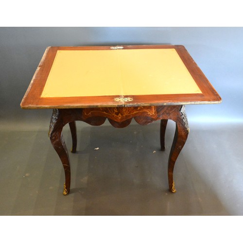 678 - A French inlaid and gilt metal mounted card table, the hinged top above a shaped inlaid frieze, rais... 