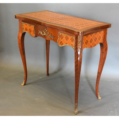 680 - A French Inlaid and Gilt Metal Mounted Card Table of serpentine form, the hinged top enclosing a bai... 