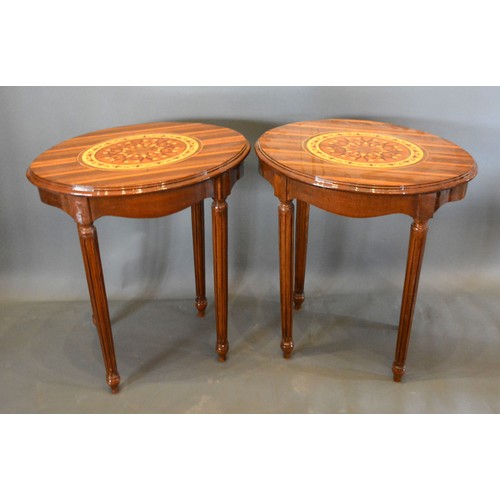 682 - A Pair of French marquetry inlaid oval lamp tables each with an oval marquetry inlaid moulded top ab... 