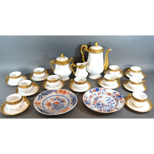 21 - A Limoges Tea Service together with a pair of iron stone plates