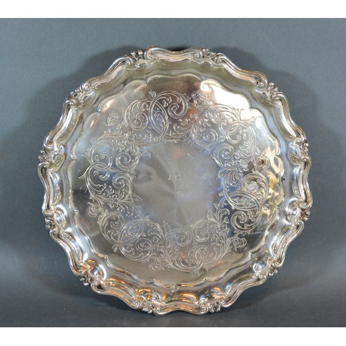 65 - A Victorian Silver Salver of shaped outline with central crest and three scroll feet, London 1844, m... 