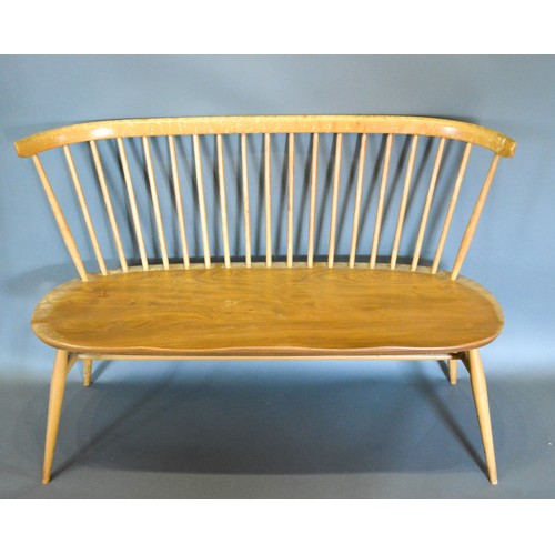 295 - An Ercol Bench Seat with spindle back above a shaped seat raised upon turned legs with stretcher 113... 