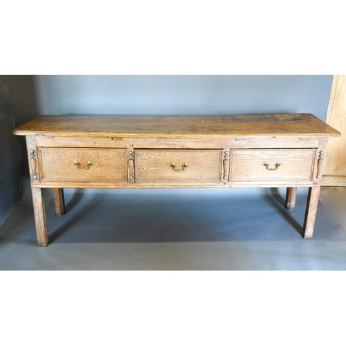 296 - A 19th Century Dresser Base, the moulded top above three drawers with brass handles flanked by stile... 