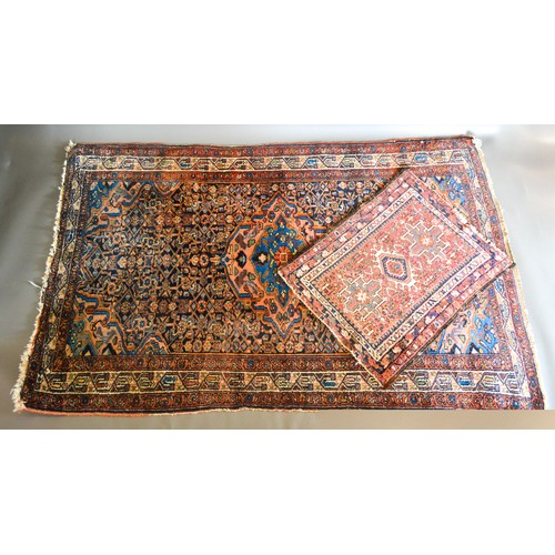 284 - A North West Persian Woollen Rug with a central medallion with an all over design upon a blue, cream... 