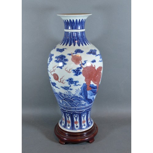 21 - A Chinese porcelain oviform vase decorated with iron red and under glaze blue and six character mark... 
