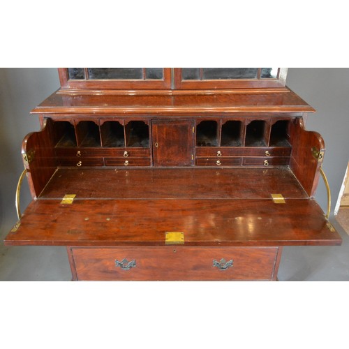 321 - A Regency mahogany secretaire bookcase, the moulded cornice above two astragal glazed doors enclosin... 