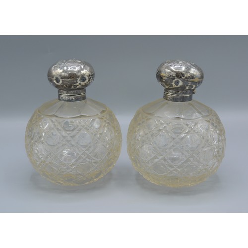 158 - A pair of Edwardian silver and cut glass large scent bottles, decorated with whispers, Birmingham 19... 