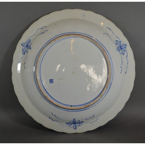 14 - A Japanese porcelain charger decorated in under glaze blue and highlighted with gilt, 41cms diameter