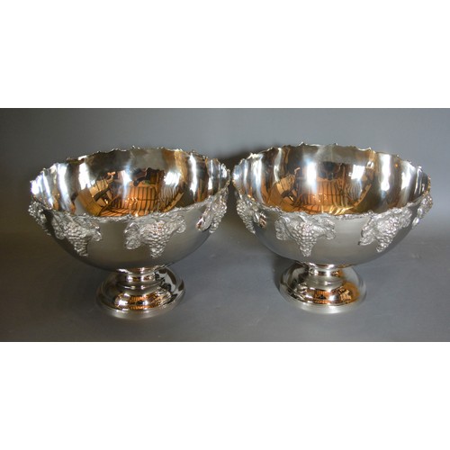 152 - A pair of large punch bowls decorated in relief with grape vine and circular pedestal bases, 39cms d... 