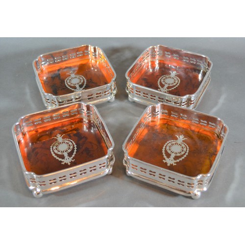 150 - A set of four simulated Totoiseshell and silver plated bottle coasters, 12cms square