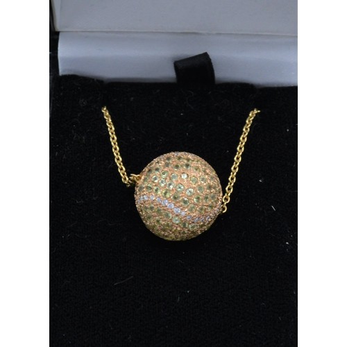 92 - An 18ct gold and diamond and green stone set pendant in the form of a tennis ball together with a li... 