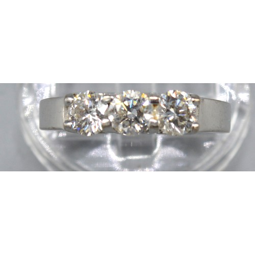 177 - A White Metal Three Stone Diamond Ring, the three diamonds claw set, 5.6gms. ring size L