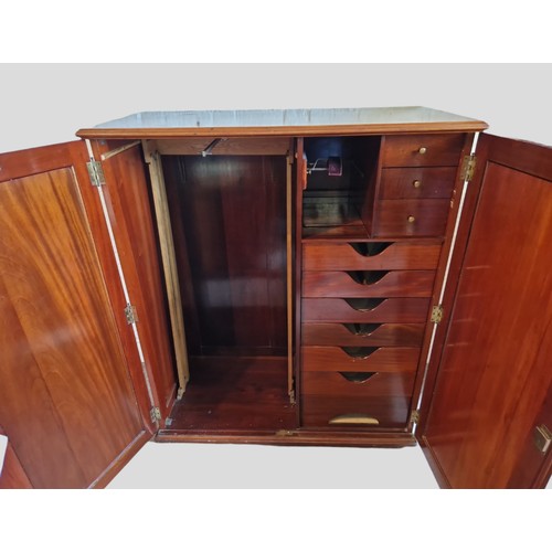 326 - A Late Victorian Mahogany Dwarf Wardrobe, the moulded top above two panel doors enclosing sliding tr... 