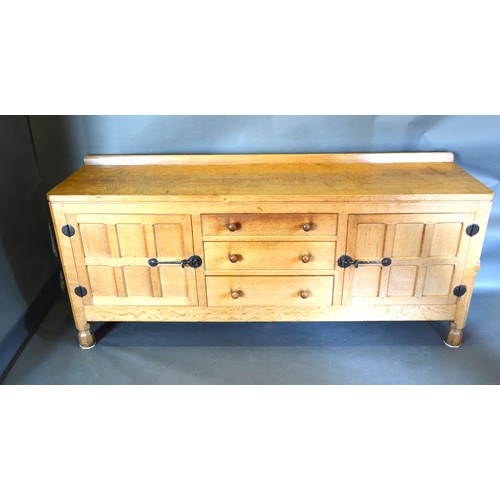 330 - Robert (Mouseman) Thompson, An Oak Sideboard with a low galleried back and adze carved top above thr... 