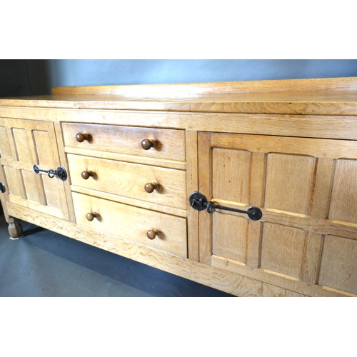 330 - Robert (Mouseman) Thompson, An Oak Sideboard with a low galleried back and adze carved top above thr... 