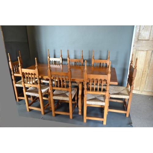 333 - A Spanish Pine Refectory Style Dining Table together with a set of eight spindle back chairs, 182cms... 