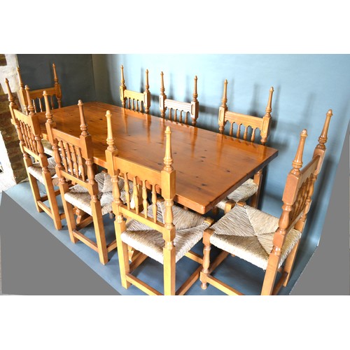 333 - A Spanish Pine Refectory Style Dining Table together with a set of eight spindle back chairs, 182cms... 