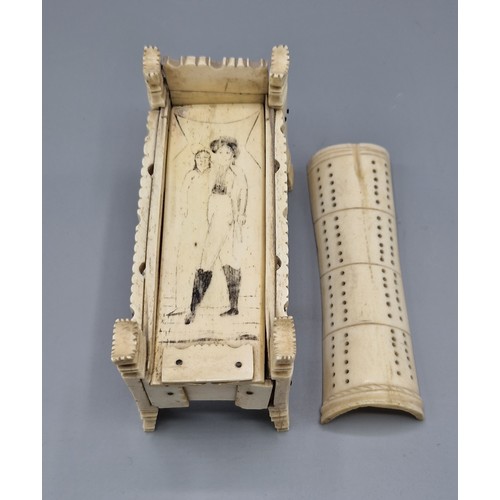 252 - A Napoleonic prisoner of war model in the form of a cradle, the scrimshaw inner cover enclosing a se... 