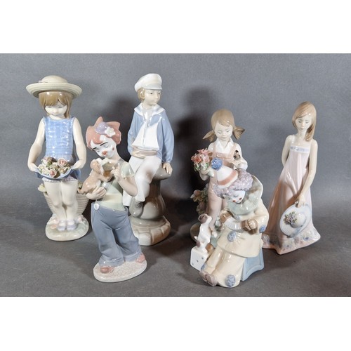 4 - A Lladro porcelain model of a boy with a sailing boat together with five other Lladro porcelain figu... 