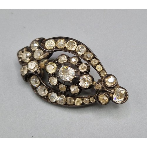 102 - An early 19th Century diamond set brooch with a central diamond surrounded by diamonds, 3.5cms long,... 