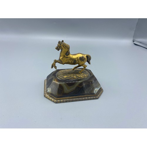 263 - An early 19th Century French patinated bronze model of a horse on Agate stand, 10cms wide, 8cms deep... 