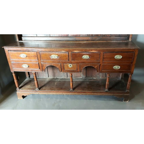 397 - A George III oak Welsh dresser, the moulded cornice above a boarded shelf back, the lower section wi... 