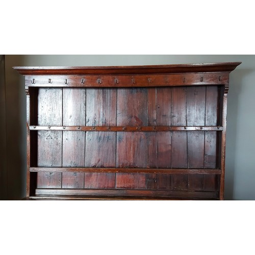 397 - A George III oak Welsh dresser, the moulded cornice above a boarded shelf back, the lower section wi... 