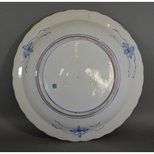 49 - A Japanese porcelain charger decorated in under glaze blue and highlighted with gilt, 41cms diameter