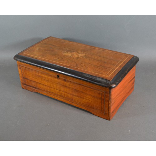 306 - A 19th Century Swiss music box, within an inlaid case, playing six air, 35cms long